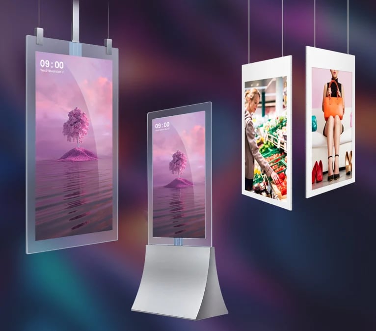 Collection of digital display kiosks showing various designs including pink landscape imagery and fashion photos against a gradient background